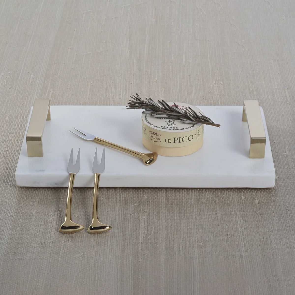 The ZODAX MARBLE TRAY WITH GOLD HANDLES is a rectangular white marble tray with two gold metal handles, ideal for serving or display, shown on a white background.