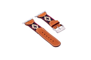 The LA MATERA - CORBINA Apple Watch Band in silver pairs artisan brown leather with a black fabric section, beige geometric pattern, and red stitching.