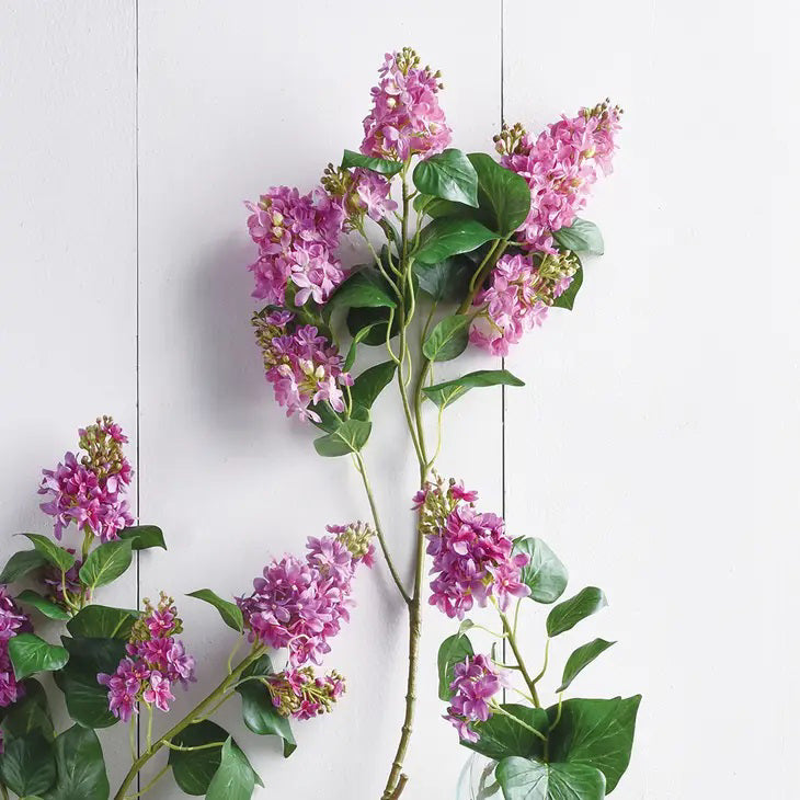 The NAPA HOME AND GARDEN - GARDEN LILAC BRANCH 37" features a slender stem with clusters of vibrant, authentic-looking pink flowers and green leaves, creating a balanced and elegant appearance against a plain white background.