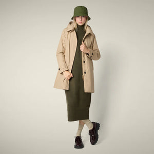 The SAVE THE DUCK - EMBIE COAT is a light beige, mid-length women's raincoat by SAVE THE DUCK, made from waterproof recycled polyester with a hood, buttoned front, side pockets, and adjustable cuffs. Shown on a plain white background.