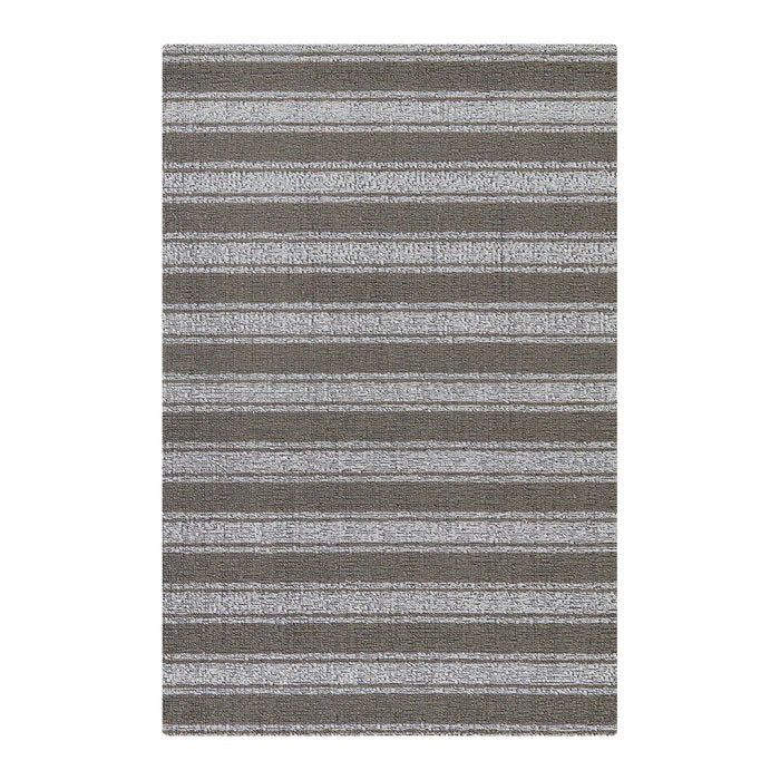 The CHILEWICH - BOARDWALK STRIPE BIG MAT by CHILEWICH is a rectangular indoor/outdoor rug with modern, textured stripes in shades of gray and taupe—perfect for contemporary spaces.