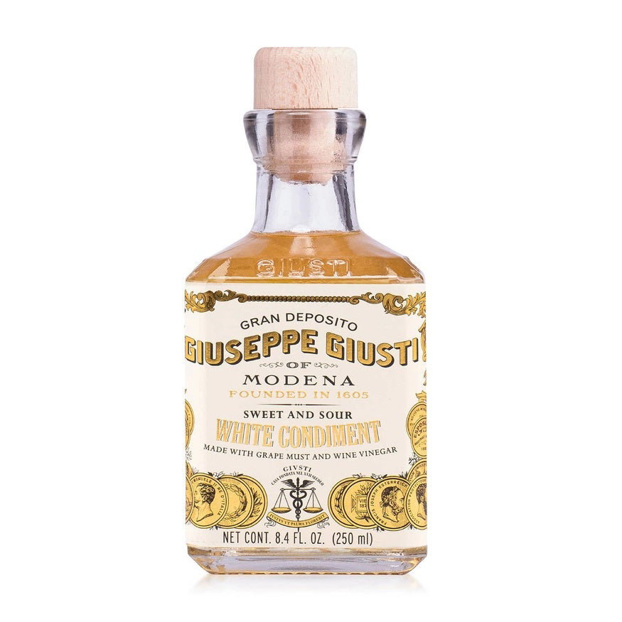 A bottle of Mercato di Bellina's Giuseppe Giusti - Italian White Wine Balsamic Vinegar is shown. The label reads "Gran Deposito Giuseppe Giusti of Modena, Founded in 1605, Sweet and Sour White Condiment, Made with Grape Must and Wine Vinegar from Trebbiano Grapes." The gourmet barrel-aged bottle has a wooden cap and contains 8.4 fl. oz. (250 ml).