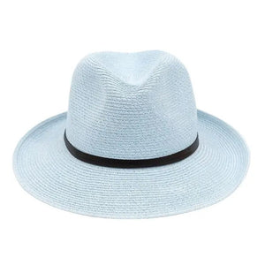The charming LEATHER TIE PAPER HAT by TRAVAUX EN COURS is a pink, lightweight, woven pattern fedora featuring a wide brim and black band on the crown, set against a plain white background.
