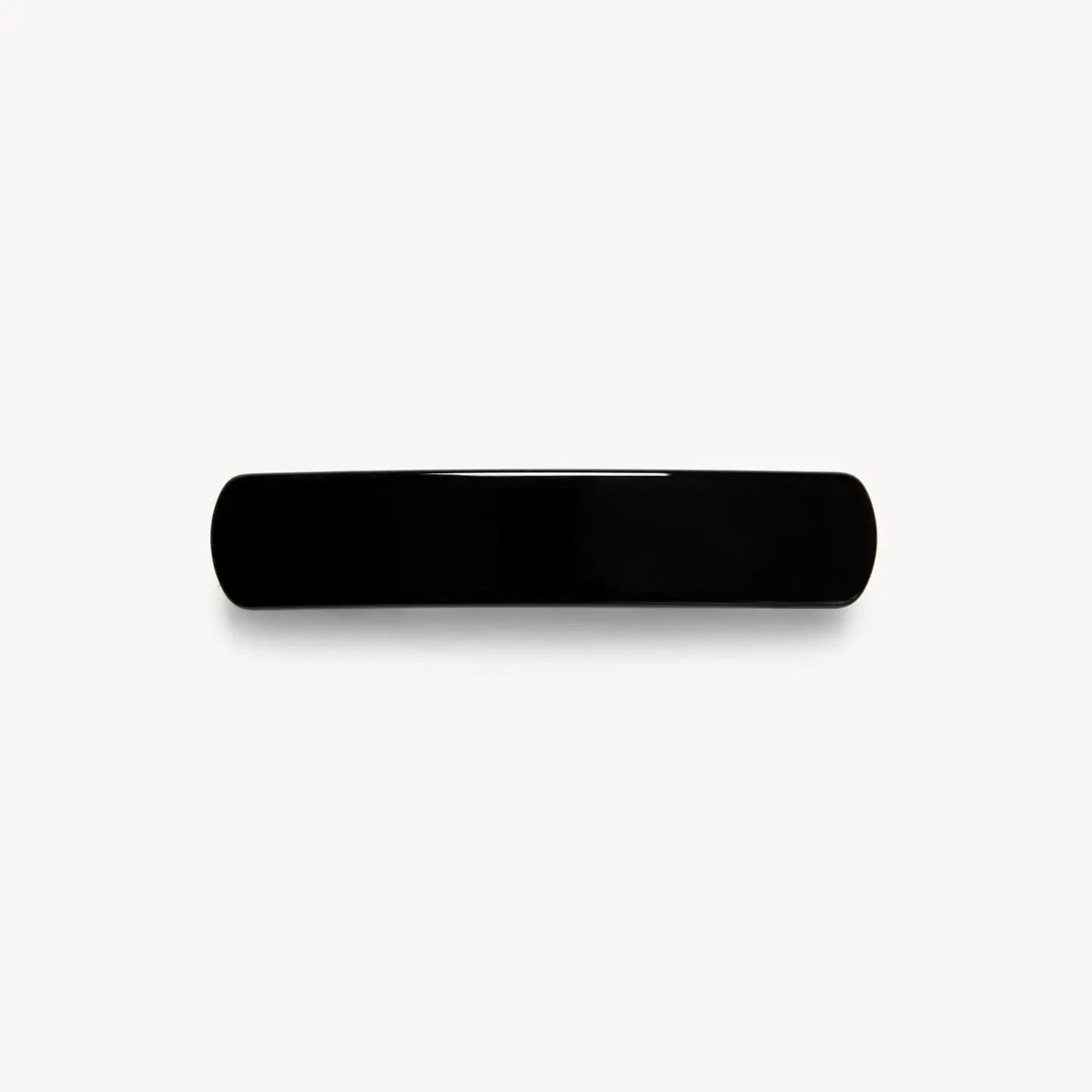 The MACHETE - NO. 3 Heirloom Barrette in Black, a sleek rectangular hair accessory with rounded edges crafted from premium cellulose acetate, is displayed against a plain white background.