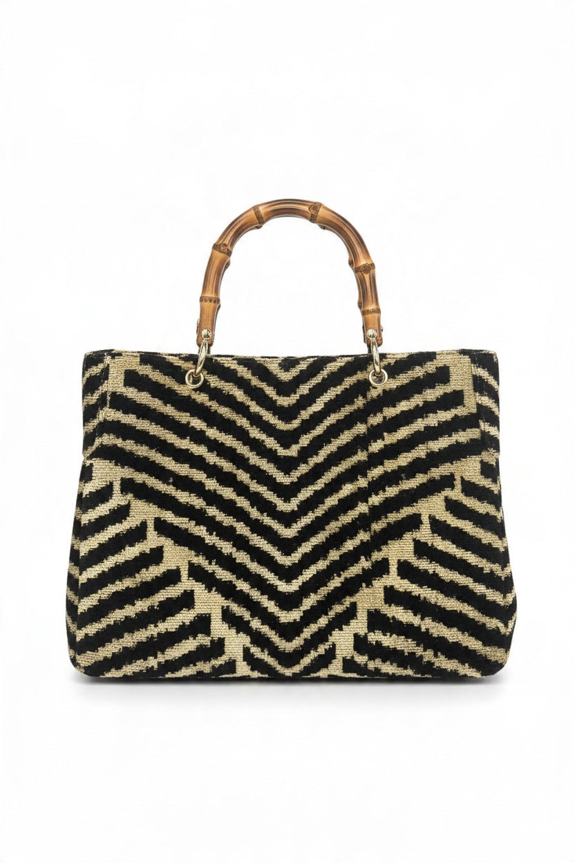 BALDIZ - DESSET ZEBRA AVERY BAMBOO BAG, a stylish tote featuring a black and tan chevron pattern and round bamboo handles.