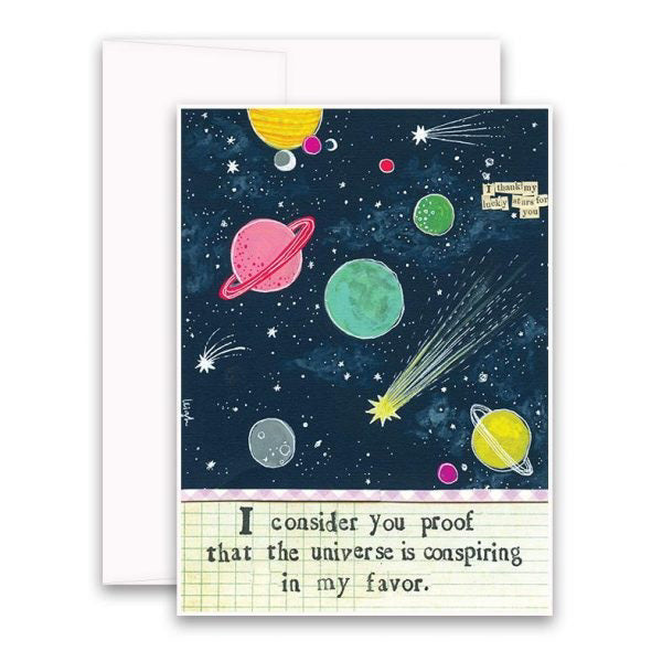 The CURLY GIRL DESIGNS - CONSIDER YOU PROOF CARD by CURLY GIRL DESIGN, INC features a beautiful illustration of planets, stars, and a comet set against a dark sky. The caption on the card reads, "I consider you proof that the universe is conspiring in my favor." An additional note on the upper right expresses, "I thank my lucky stars for you every day.