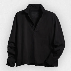 The FRANK & EILEEN PATRICK POPOVER HENLEY in Heritage Jersey Black features a sporty V-neck with a collar and raw-cut hem, set against a light, textured background.