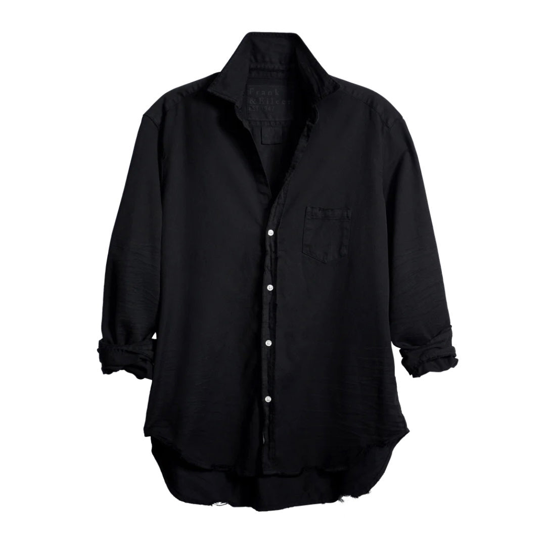 The FRANK &amp; EILEEN Eileen Relaxed Button-Up in Black Tattered Denim provides a relaxed fit with long sleeves that can be stylishly rolled up. It includes a single breast pocket on the left side and features a slightly curved hem, complemented by bust-enhancing button placement for added elegance.