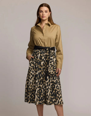 A woman wears the HINSON WU Robin Long Sleeve Combo Dress in animal print, featuring a tan button-up top and high-waisted leopard skirt with a black belt, set against a plain light background.