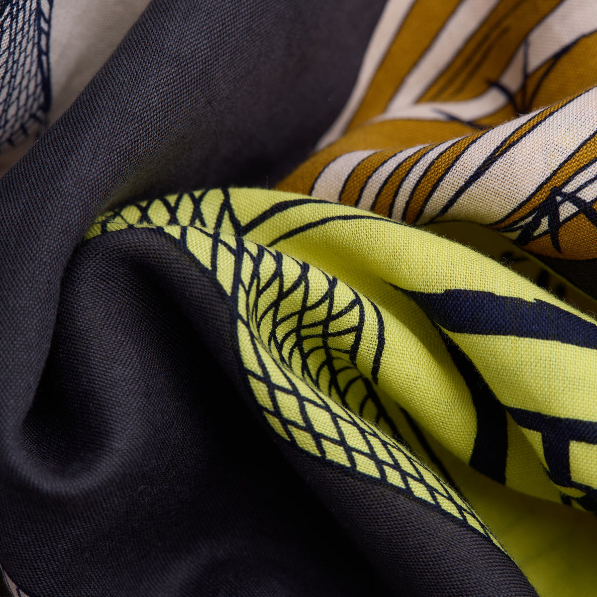 The INOUI EDITIONS - TEQUILA SCARF IN LEMON by INOUI features vibrant cacti and succulents in green, yellow, and white on brown and gray pedestals, set against a dark gray background with a decorative border.