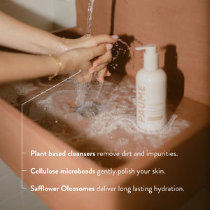 A bottle of PAUME - EXFOLITAING HAND SOAP, a moisturizing hand wash with pump, is displayed against a light beige background. The label shows tan and peach text with the product name and description.