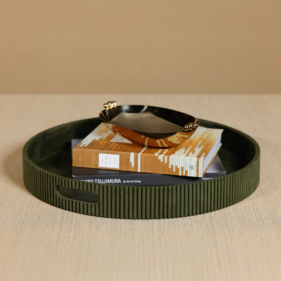 Close-up of the ZODAX ROUND FLUTED LEATHER TRAY IN GREEN, showcasing a smooth top and vertical, evenly spaced ridges on the sides for a modern, textured look.