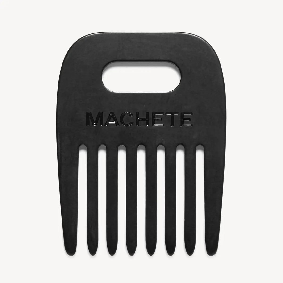The MACHETE - NO. 4 COMB IN MATTE BLACK is a wide-tooth hair pick made from Italian acetate, featuring a rectangular grip hole and "MACHETE" embossed above the teeth—ideal for curly hair, displayed on a white background.