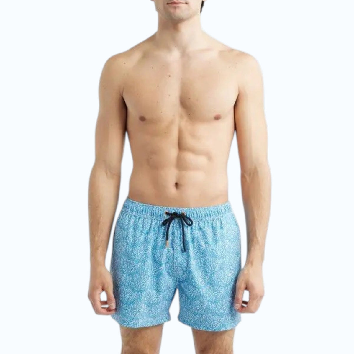 A shirtless man wears SAVE THE DUCK - ADEMIR swim trunks in light blue corals NO FISHING, made from quick-dry recycled polyester with a black drawstring, standing against a plain white background.