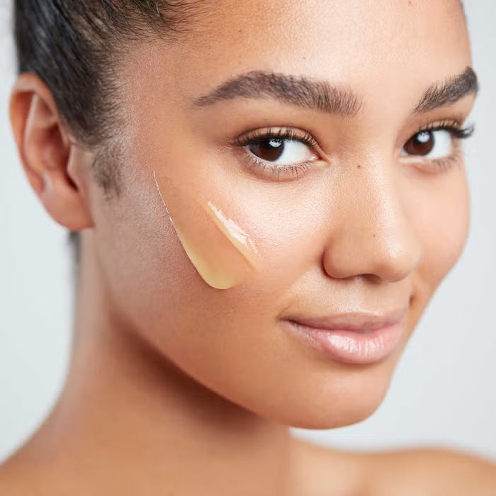 A jar of ELEMIS - PRO-COLLAGEN GREEN FIG CLEANSING BALM by ELEMIS - STEINER is depicted with its lid removed, exposing the yellow balm within. The text on the green jar states &quot;Hydrating cleansing balm.&quot; Centered on a white background, this jar highlights nourishing plant oils designed to deeply cleanse your skin.