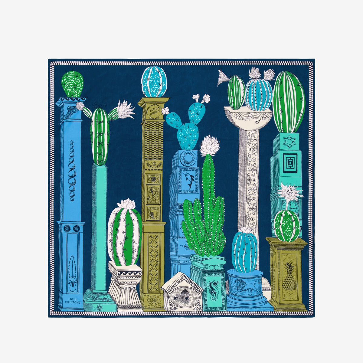 A woman with dark hair tied back wears a white outfit, accessorized with the INOUI EDITIONS - TEQUILA SCARF IN CURACAO by INOUI, featuring green, yellow, and blue patterns, set against a plain white background.