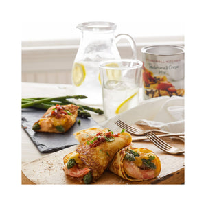 A canister of STONEWALL KITCHEN - TRADITIONAL CREPE MIX, perfect for breakfast, with crepes topped with strawberries and chocolate on the packaging. Net weight: 16 oz (454g).