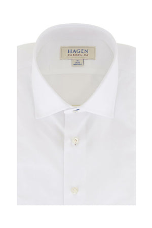 Close-up of the HAGEN - COTTON DRESS SHIRT IN WHITE, neatly folded with a modern spread collar and white buttons. A label inside the collar displays "HAGEN.