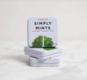 A metal tin labeled "SIMPLY GUM - AWAKEN WITH CAFFEINE MINTS" in large text, with "Peppermint + Matcha" written beneath. The tin features images of green matcha powder and peppermint leaves, and the product weight is 1.06 oz (30g) displayed at the bottom right corner.