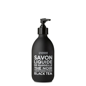 A black pump dispenser bottle labeled "COMPAGNIE DE PROVENCE - SAVON LIQUIDE DE MARSEILLE BLACK TEA SOAP" by CIE LUXE BRANDS, featuring sulphate-free liquid soap enriched with botanical oils in elegant white text.