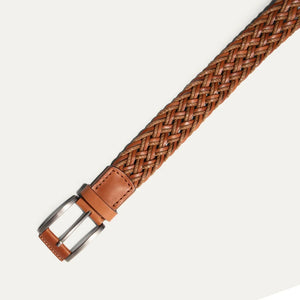 Close-up of the WILL LEATHER GOODS Leather Braided Wax Cord Belt in tan, featuring a handcrafted braided design with a solid leather tip, displayed on a plain white background.