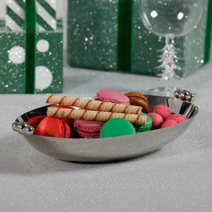 The ZODAX POLISHED NICKEL SERVING BOWL is a shiny, oval-shaped silver decorative bowl featuring two polished nickel round handles on opposite sides, displayed against a white background.