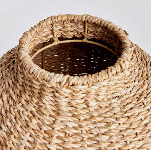 The NAPA HOME AND GARDEN - SEAGRASS ROUND VASE features a wide, round body and a narrow opening, crafted from natural, light-colored fibers and displayed against a plain white background.