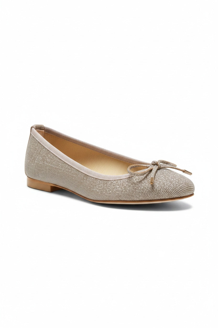 The MICHELE LOPRIORE MIA BALLET FLAT, crafted in sparkly light gold genuine leather and adorned with small bows on the front, is displayed on a light textured background.