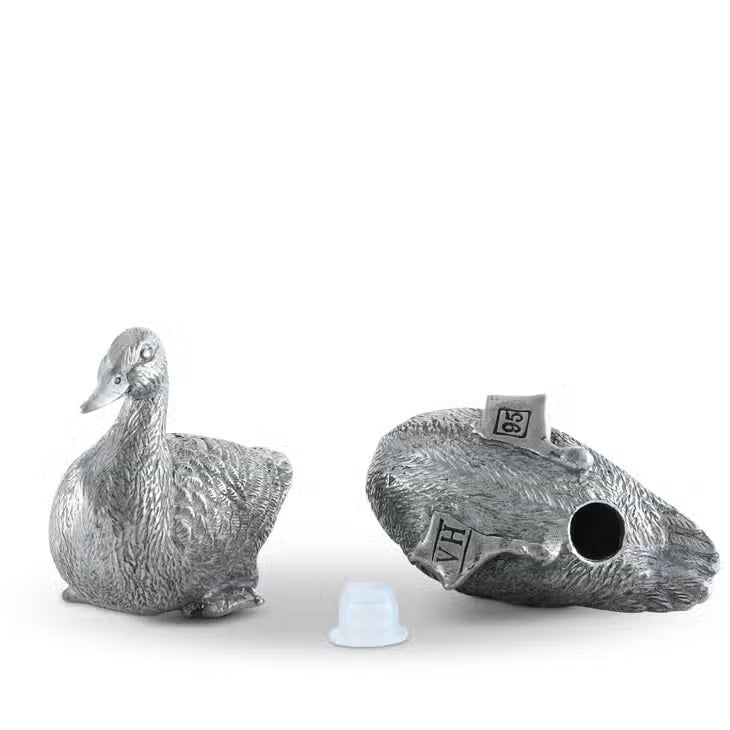 VAGABOND HOUSE&#39;s Pewter Duck Salt and Pepper Set showcases two ducks with detailed feather engravings, sitting slightly forward with dispensing holes on their backs.