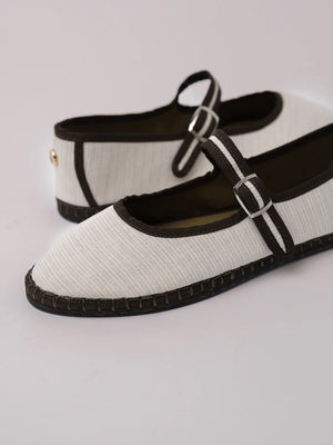 A single SVETI STEFAN - MARY JANE SHOE with a buckle strap, handmade in Spain, is displayed on a plain light background. The shoe features a dark pink body with lighter pink trim and a light pink sole, all crafted from cotton fabric.