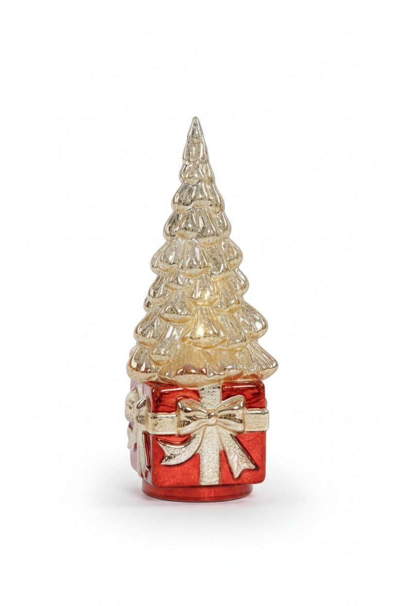 A ZODAX LED ROTATING TREE ON PRESENT, featuring a decorative glass Christmas tree with a light-up finish, sits atop a red gift box base accented with a gold ribbon.