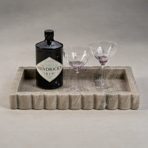 The ZODAX INTRICATE SCALLOP MARBLE TRAY is a rectangular, shallow serving tray crafted from textured gray marble with wavy, scalloped edges, shown on a white background.