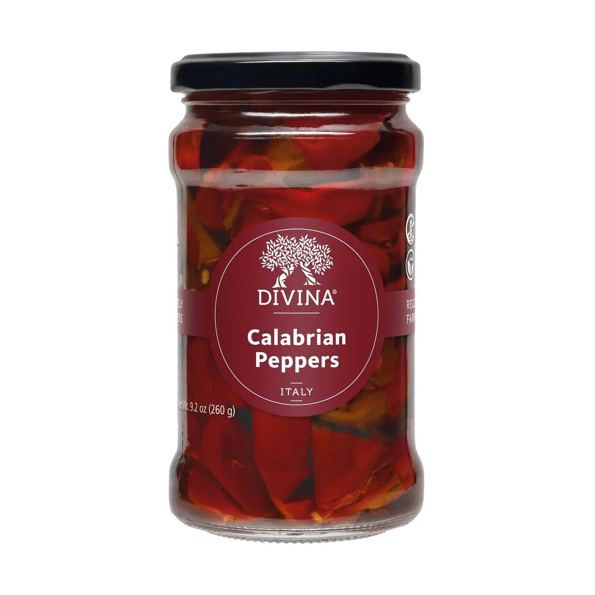A blue bowl filled with vibrant red DIVINA - CALABRIAN PEPPERS, their stems still attached, sits on a beige cloth with dark stripes atop a wooden surface.