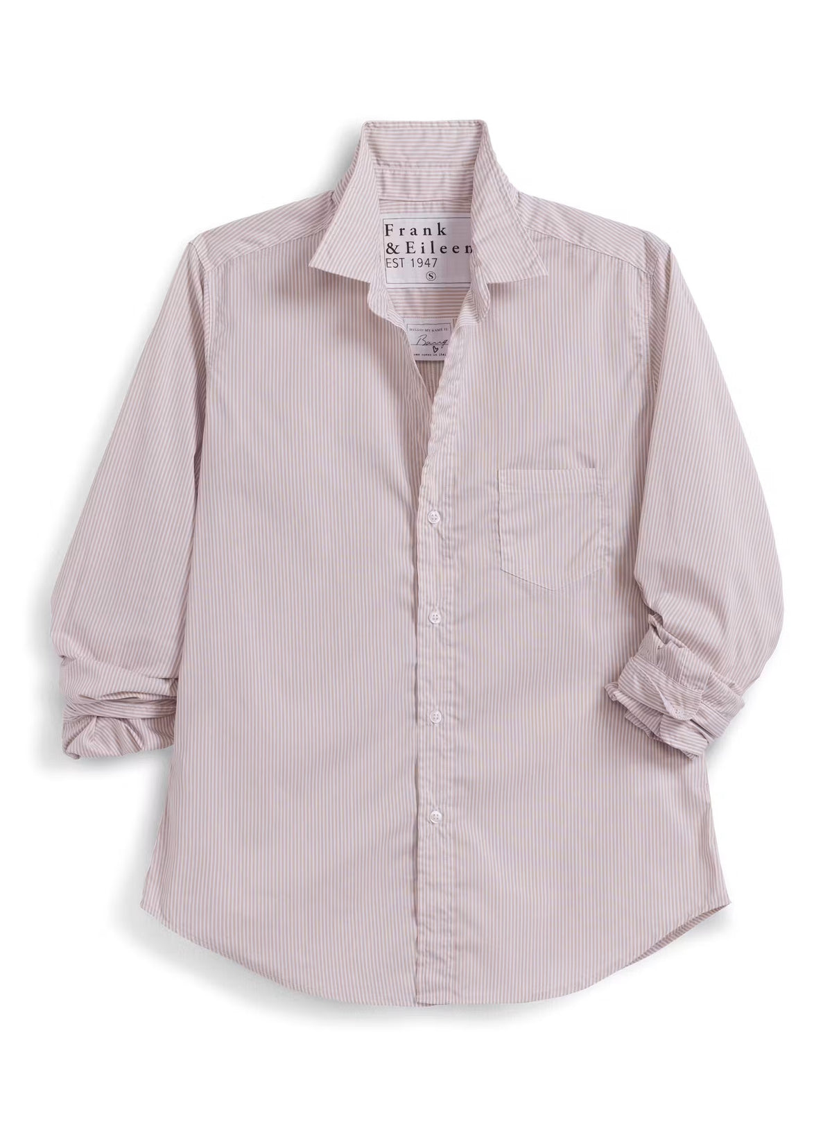 Wearing the FRANK & EILEEN EILEEN Relaxed Button Up in Italian Cotton Tan Stripe and a pair of jeans, a woman strolls down a sunny, café-lined street, smiling as she passes by tables and people. The shirt’s flattering bust button placement adds an elegant touch to her effortless style.