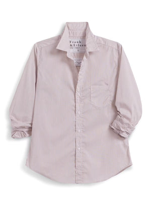 Wearing the FRANK & EILEEN EILEEN Relaxed Button Up in Italian Cotton Tan Stripe and a pair of jeans, a woman strolls down a sunny, café-lined street, smiling as she passes by tables and people. The shirt’s flattering bust button placement adds an elegant touch to her effortless style.