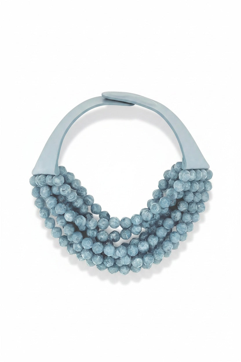 The FAIRCHILD BALDWIN - THE BELLA NECKLACE showcases layered strands of iridescent green Italian resin beads with a faceted design for a shimmering effect, finished with a smooth light green clasp that complements its vibrant hues.