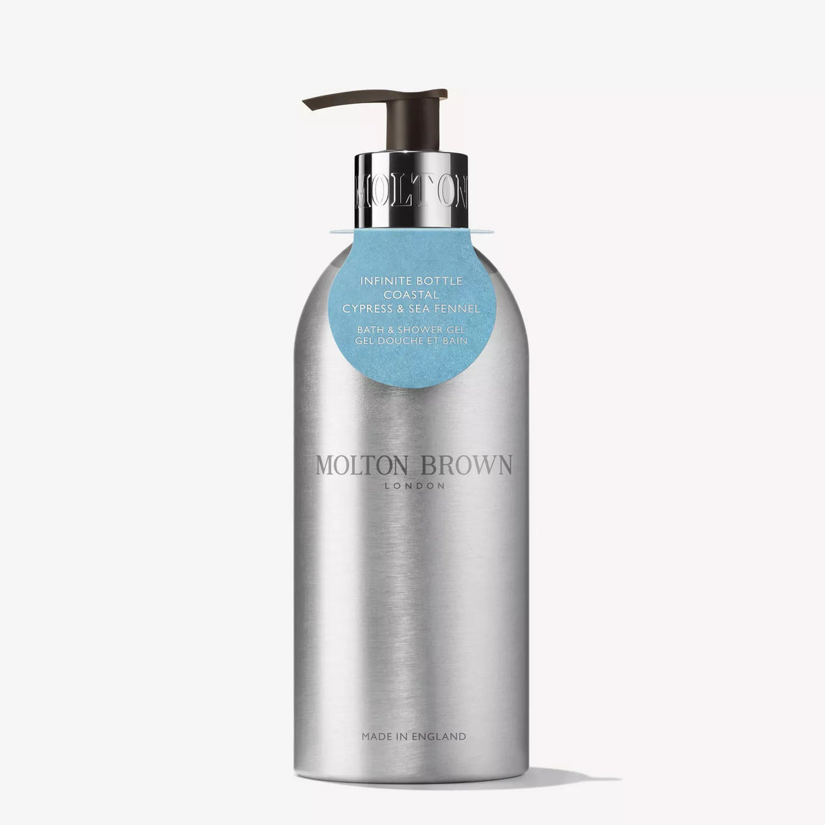 A sleek silver recycled aluminium "MOLTON BROWN - COASTAL CYPRESS INFINITE BOTTLE BODY WASH" features eco-friendly, minimalist design and elegant English craftsmanship, with a blue tag highlighting its sustainable appeal.