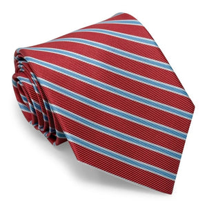 The COLLARED GREENS - WHITMAN TIE IN CORAL AND LIGHT BLUE by BIRD DOG BAY is a rolled-up coral necktie featuring diagonal light blue and white stripes, displayed on a white background. Crafted from premium materials, this versatile striped tie elevates any outfit with a touch of sophistication.