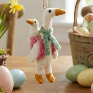 MOTHER GOOSE ORNAMENT by FELT SO GOOD, a handmade needle felted white bird wearing a green scarf and carrying a smaller goose on its back.