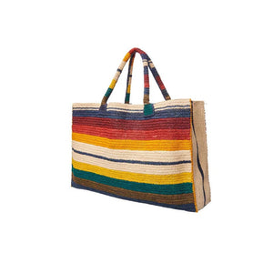 The GABRIELE FRANTZEN LITTLE SISTER WEEKENDER BAG HORIZON features a rectangular shape, handles, and vibrant horizontal stripes in red, yellow, cream, orange, blue, and green on white. This natural fiber bag brightens everyday style.