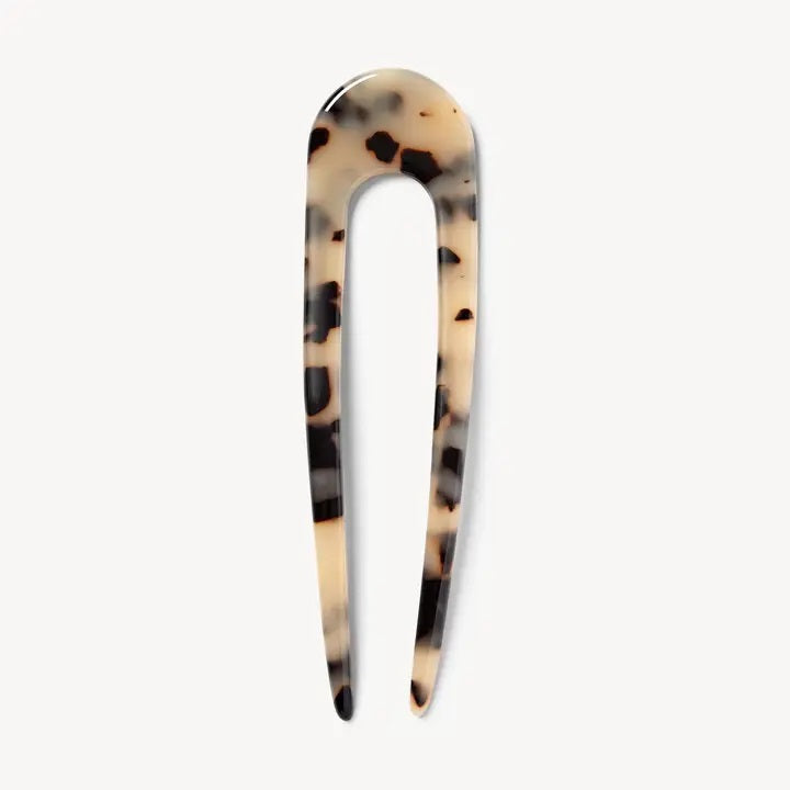 A smooth, black MACHETE - FRENCH HAIR PIN with two prongs, crafted from Italian acetate by MACHETE, rests on a plain white surface.