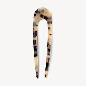 A smooth, black MACHETE - FRENCH HAIR PIN with two prongs, crafted from Italian acetate by MACHETE, rests on a plain white surface.