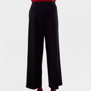 A pair of MEIMEIJ - Pull On Straight Leg Long Pants in black with a red waistband peeking out from the top, worn by a person against a light gray background. These full-length pants from MEIMEIJ feature a clean, minimalist design with no visible pockets or embellishments; they might just become your new favorite.
