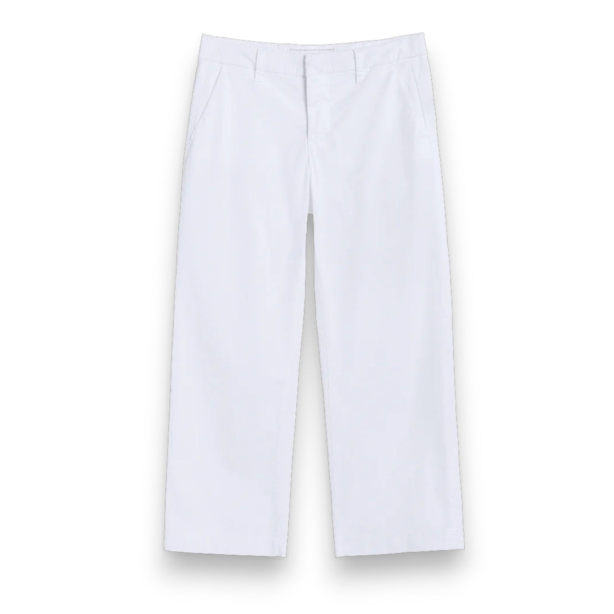 Outdoors on a pathway, a person wears FRANK &amp; EILEEN&#39;s WESTPORT Italian Wide Leg Chino in Performance Twill White, paired with a light pink long-sleeve top and beige slide sandals. Green grass and blurred shrubbery appear in the background.