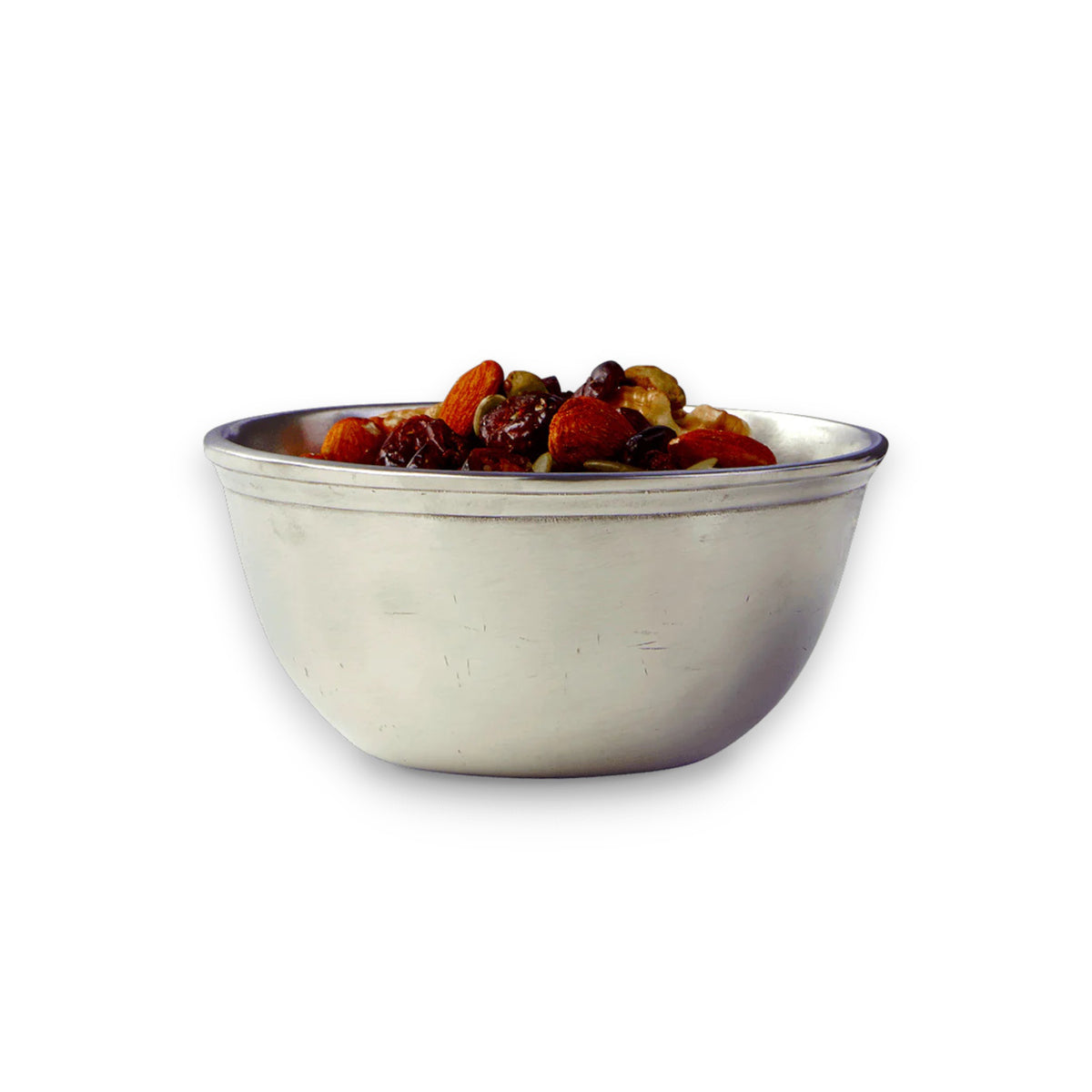 MATCH’s PEWTER LITTLE BOWL by MATCH, filled with assorted almonds, cashews, and raisins, sits elegantly against a white background—an ideal hostess gift that’s both food safe and stylish.