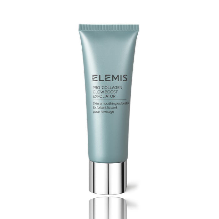 A tube of ELEMIS - PRO-COLLAGEN GLOW BOOST EXFOLIATOR by ELEMIS - STEINER lies next to a dollop of its contents on a light surface. Text explains the key ingredients: starflower oil, rose &amp; mimosa waxes, padina pavonica, and cellulose exfoliating beads, highlighting their benefits.