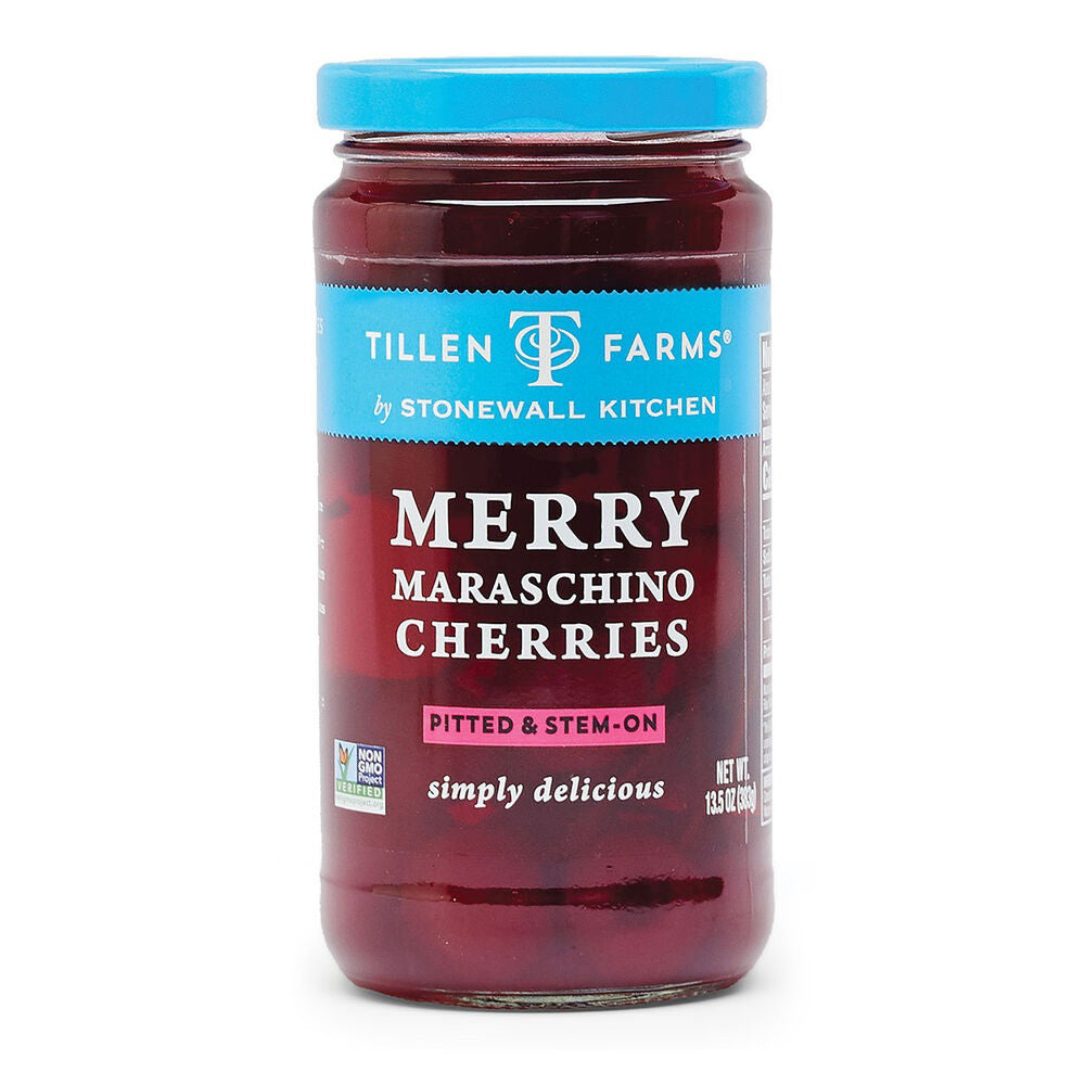 A jar of Stonewall Kitchen Merry Maraschino Cherries features a blue lid and label. These pitted, stem-on cherries are sourced from the Pacific Northwest. The label proudly displays &quot;simply delicious&quot; and &quot;non-GMO&quot; markers. Each jar has a net weight of 13.5 oz (383g).