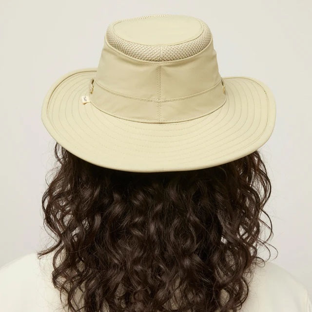 The TILLEY AIRFLO Broad Brim Hat LTM6 in Khaki Olive features mesh ventilation around the crown for outdoor use. Shown on a plain light background, this wide-brimmed sun protection hat is crafted by TILLEY.