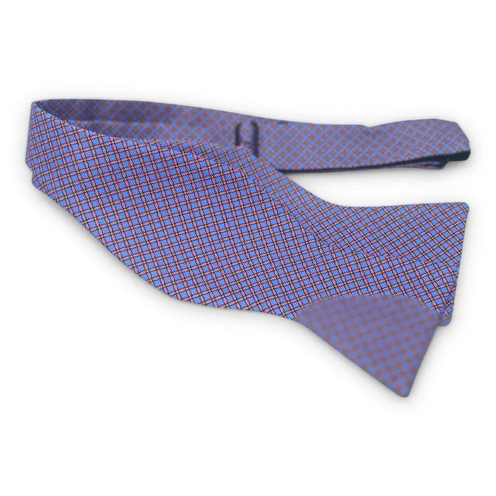 The BIRD DOG BAY PETER-BLAIR Cushions Silk Bow Tie in Blue features a handmade grid pattern with intersecting lines, creating a stylish diamond-shaped design that adds elegance to any formal outfit.
