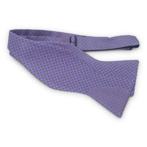 The BIRD DOG BAY PETER-BLAIR Cushions Silk Bow Tie in Blue features a handmade grid pattern with intersecting lines, creating a stylish diamond-shaped design that adds elegance to any formal outfit.